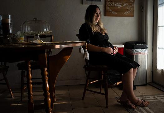 Person sitting on a chair by a window